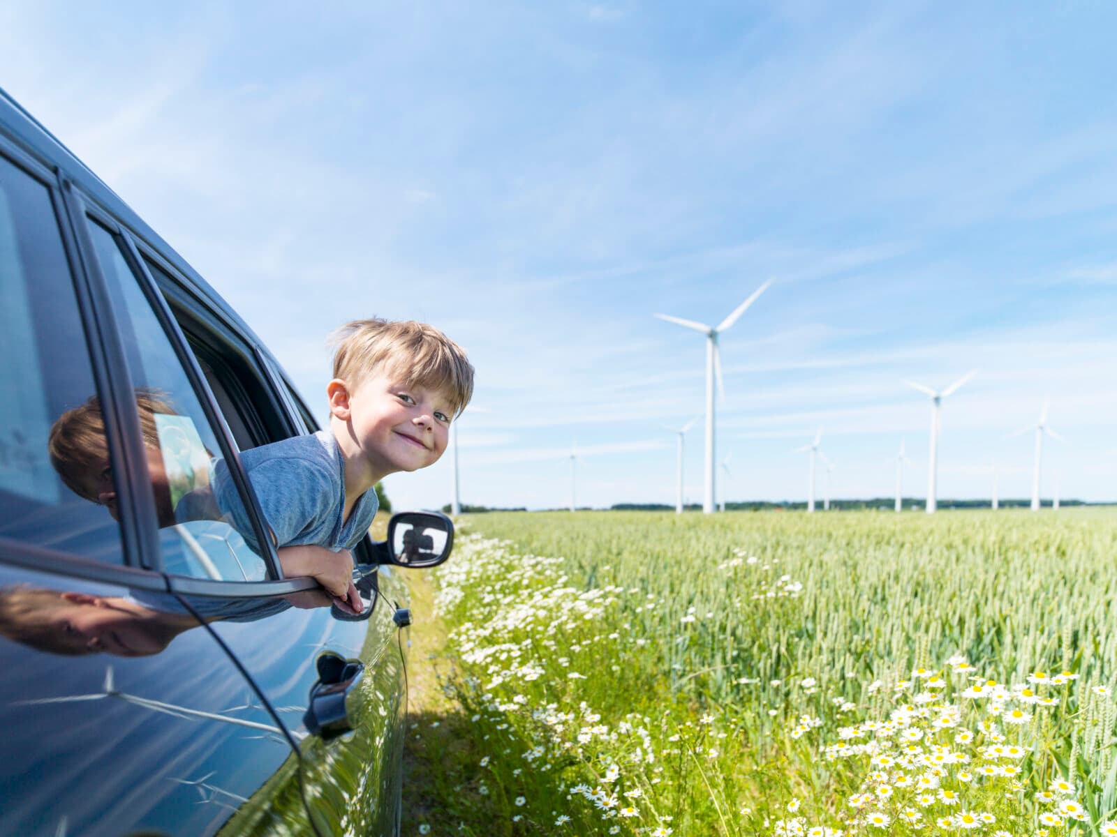 blonde, boys, car, car holiday, clear sky, climate smart, cultivate, cultivated field, day, elementary age, energy, environment, environment-friendly, field, field of corn, Halland, head and shoulders, holiday, horizontal, look, looking at camera, motoring, one person only, outdoors, plants, point of view, portrait, real people, renewable energy, rural scene, Scandinavia, short hair, side view, slideshow70, smiling, summer, sunny, Sweden, traffic, travel, Varberg, waist up, wheat field, wildflowers, wind turbines, pojke, bil, vindkraft, vindkraftverk, sommar, vind,