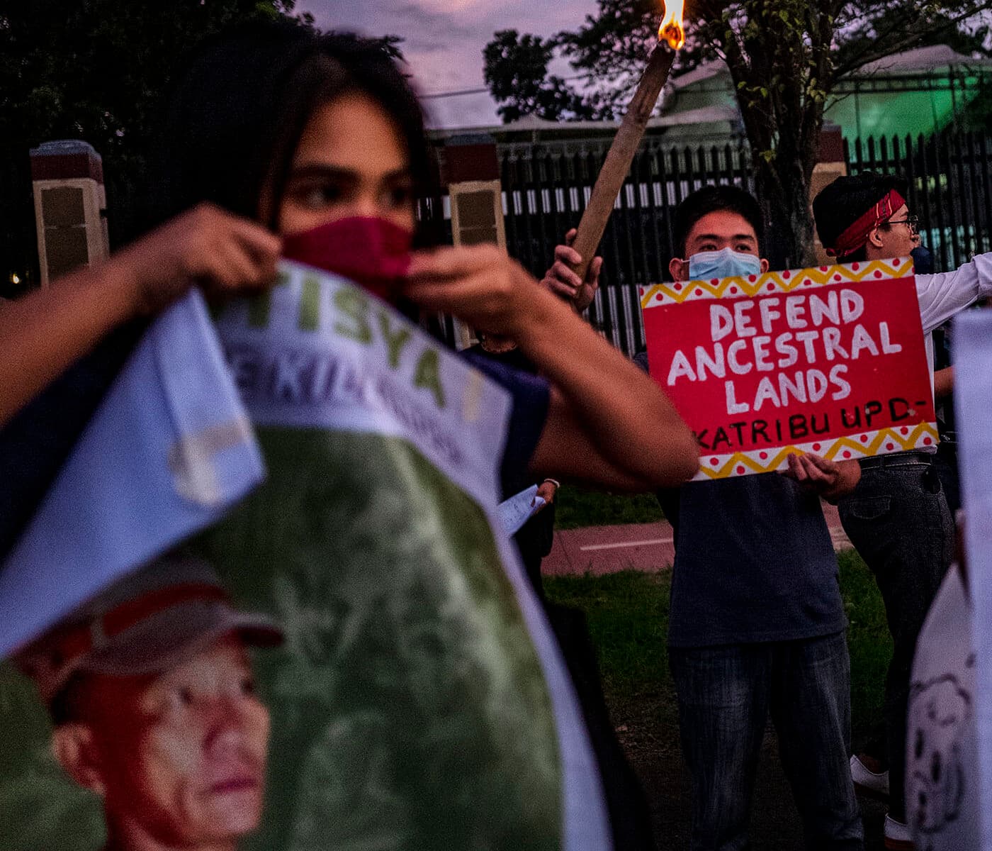 MANILA, PHILIPPINES - NOVEMBER 10: Activists hold up torches and portraits of slain indigenous peoples and environmental defenders during a rally on November 10, 2022 in Quezon city, Metro Manila, Philippines. As world leaders convene for the 27th United Nations Climate Change Conference of the Parties (COP27) in Egypt, the Philippines continues to be among those in the top list of the most murderous countries for indigenous peoples and environment defenders. Groups and individuals opposing damaging industries and corporate forest and natural resources destruction are often met with violent crackdowns from the police and military. International non-profit Global Witness has recorded incidents in relation to defenders’ opposition to mining, logging, and dam projects. (Photo by Ezra Acayan/Getty Images)