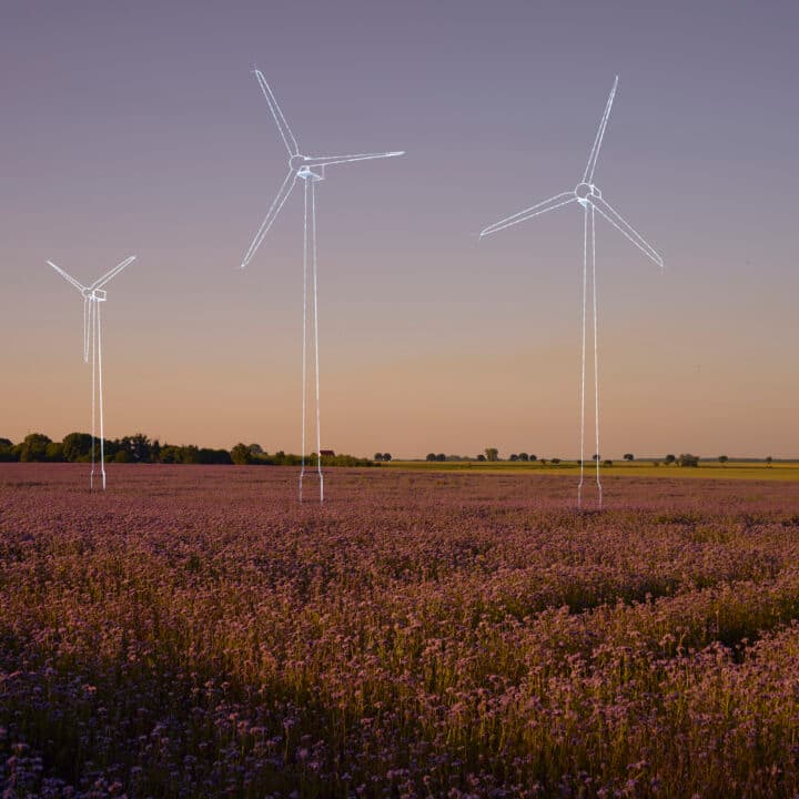 Digital generated image of hand drawn wind turbines overlaid over flower field on sunset. ...