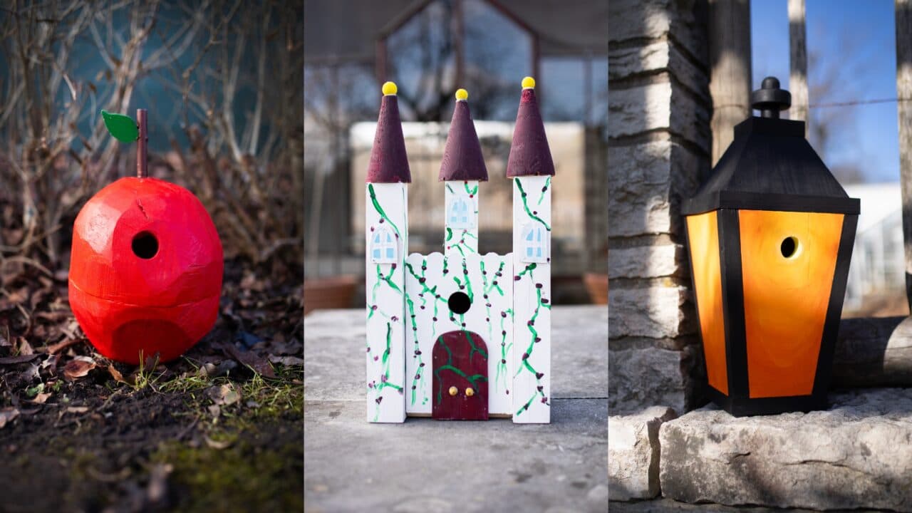 Fågelholkar i form av ett rött äpple, ett vitt slott med tre torn, och en svart lykta med gult sken. ...